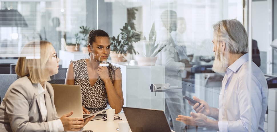 2 women and 1 man in a work discussion