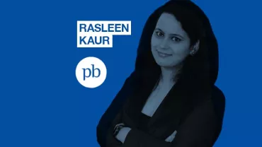 Woman posing confidently with arms crossed, blue background, text 'Rasleen Kaur' and 'pb' logo alongside.